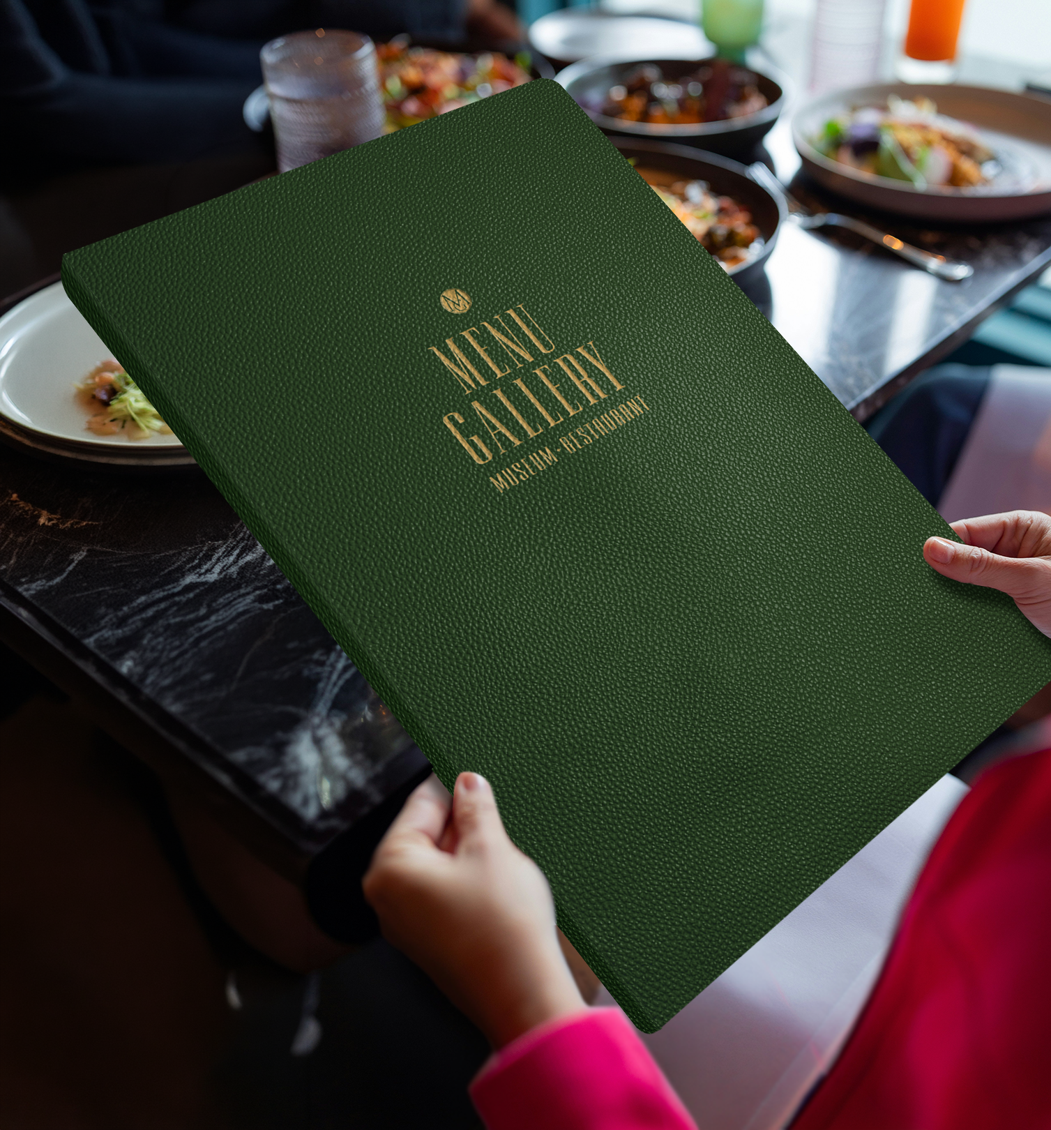The Menu Gallery menu — dark green leather with a gold-foil logo, presented tableside